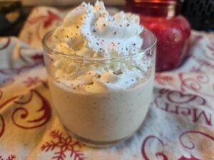 Close-up of sugar-free eggnog topped with whipped cream and nutmeg
